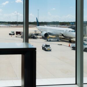 Airport terminal view overlooking airplane and tarmac